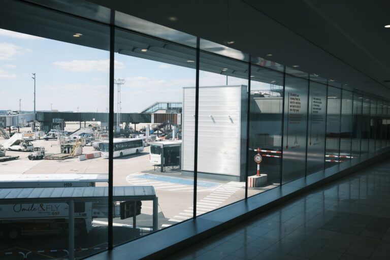 Crowded airport departure terminal with travelers carrying luggage