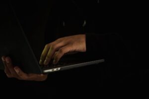 A person adjusting privacy and security settings on a laptop computer