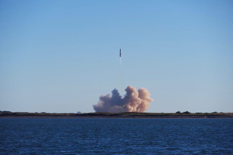 A rocket on a launch pad at dusk, preparing for liftoff
