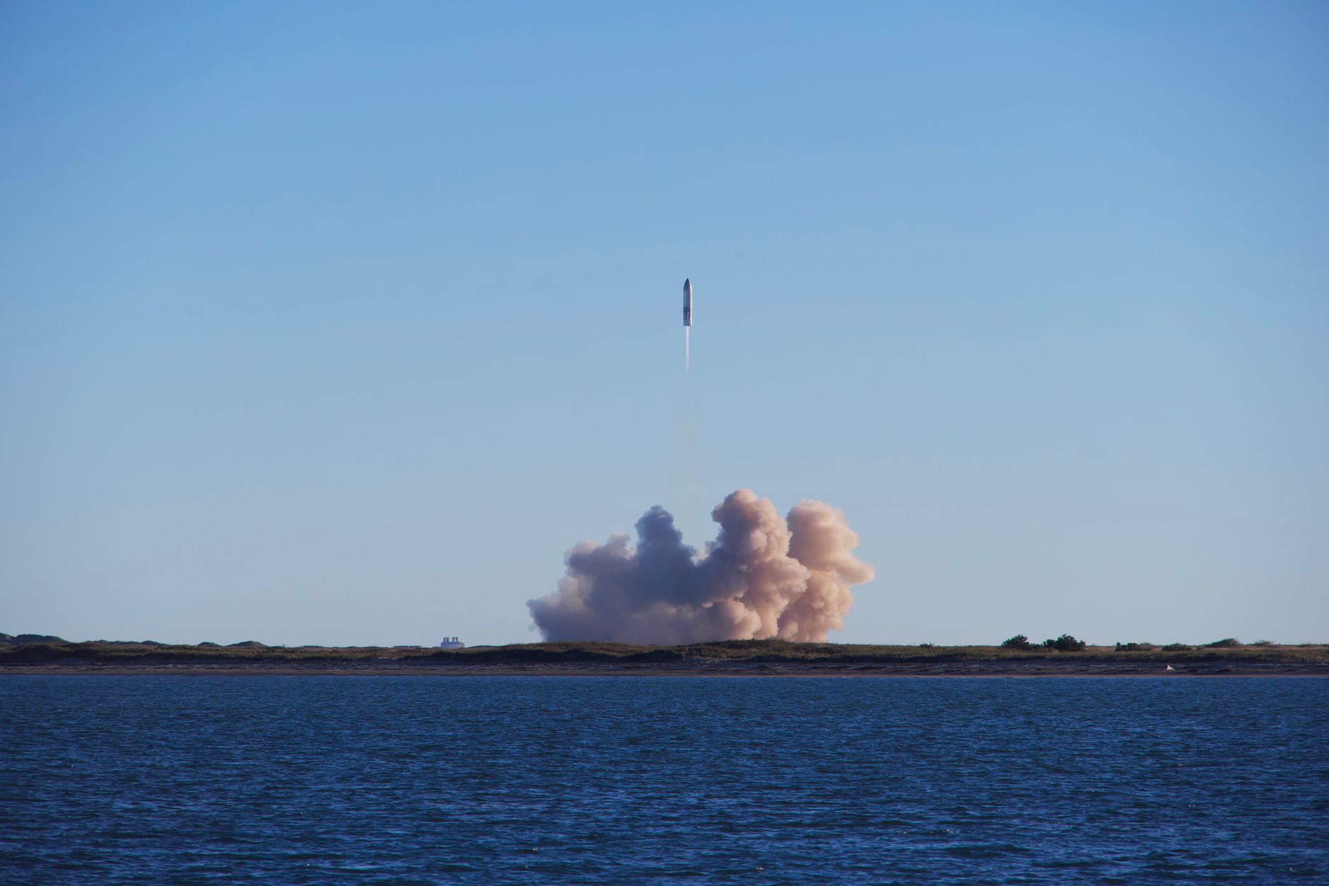 A rocket on a launch pad at dusk, preparing for liftoff