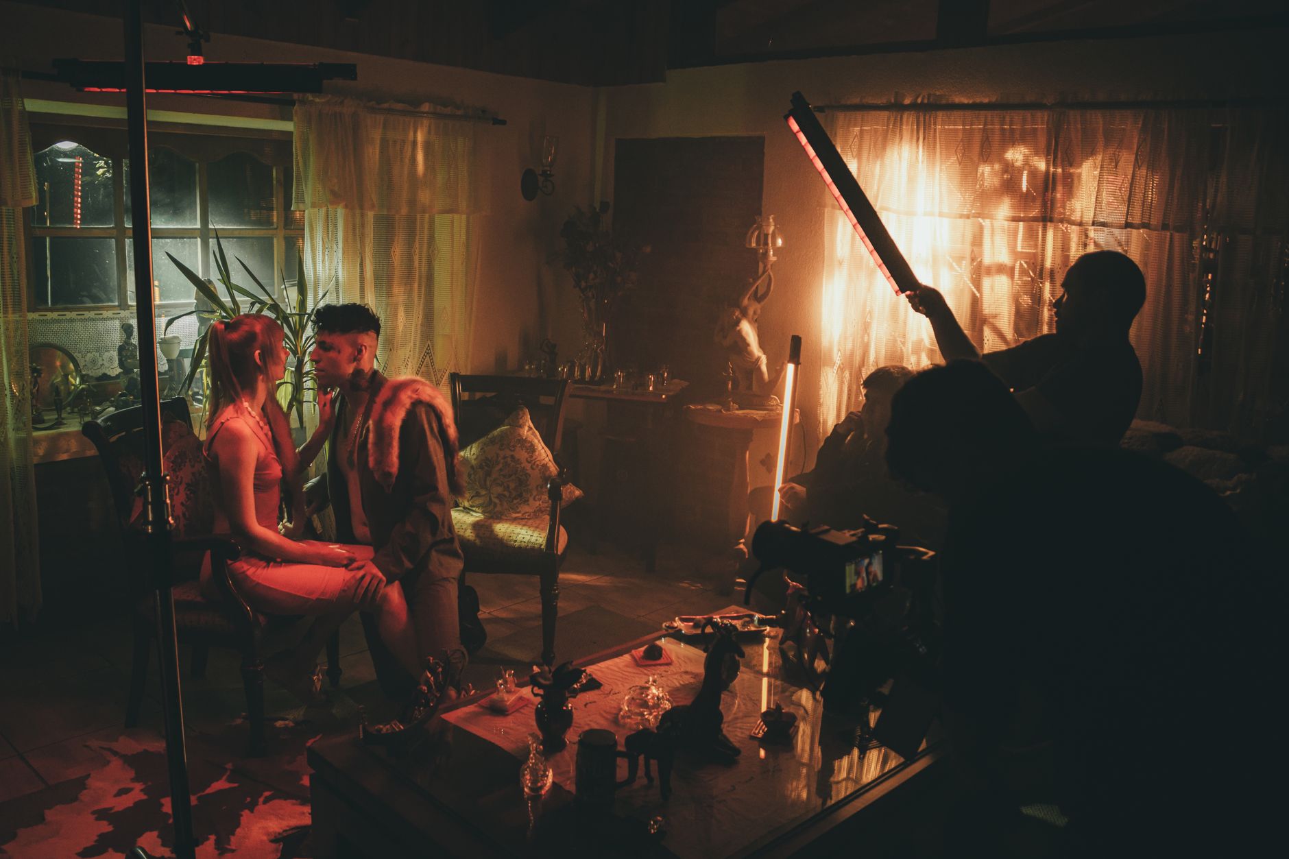 A dramatic film production set with moody lighting suggesting a serious narrative
