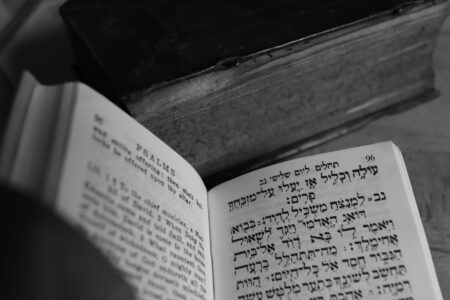 Open book on a desk beside a notebook, suggesting literary translation work