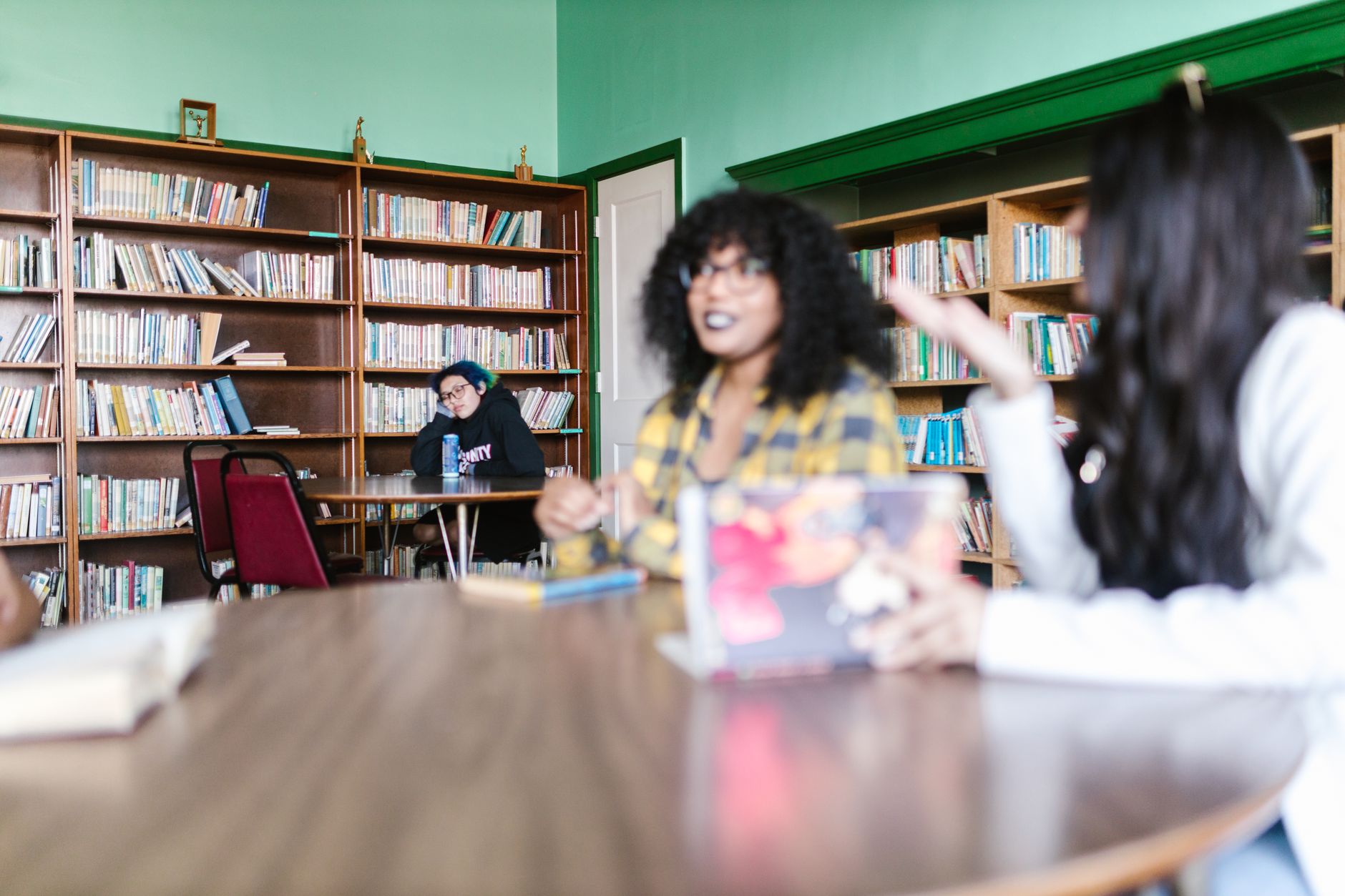 Small group of students gathered around books in a university setting
