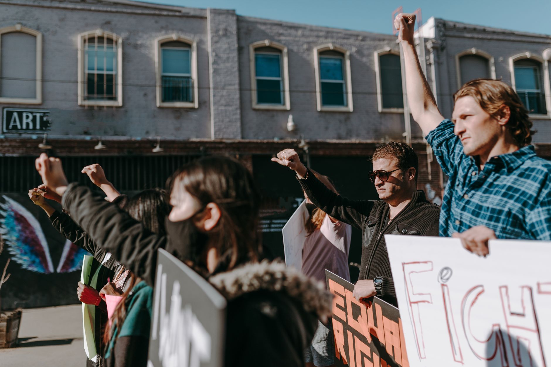 Protesters holding signs at a street demonstration