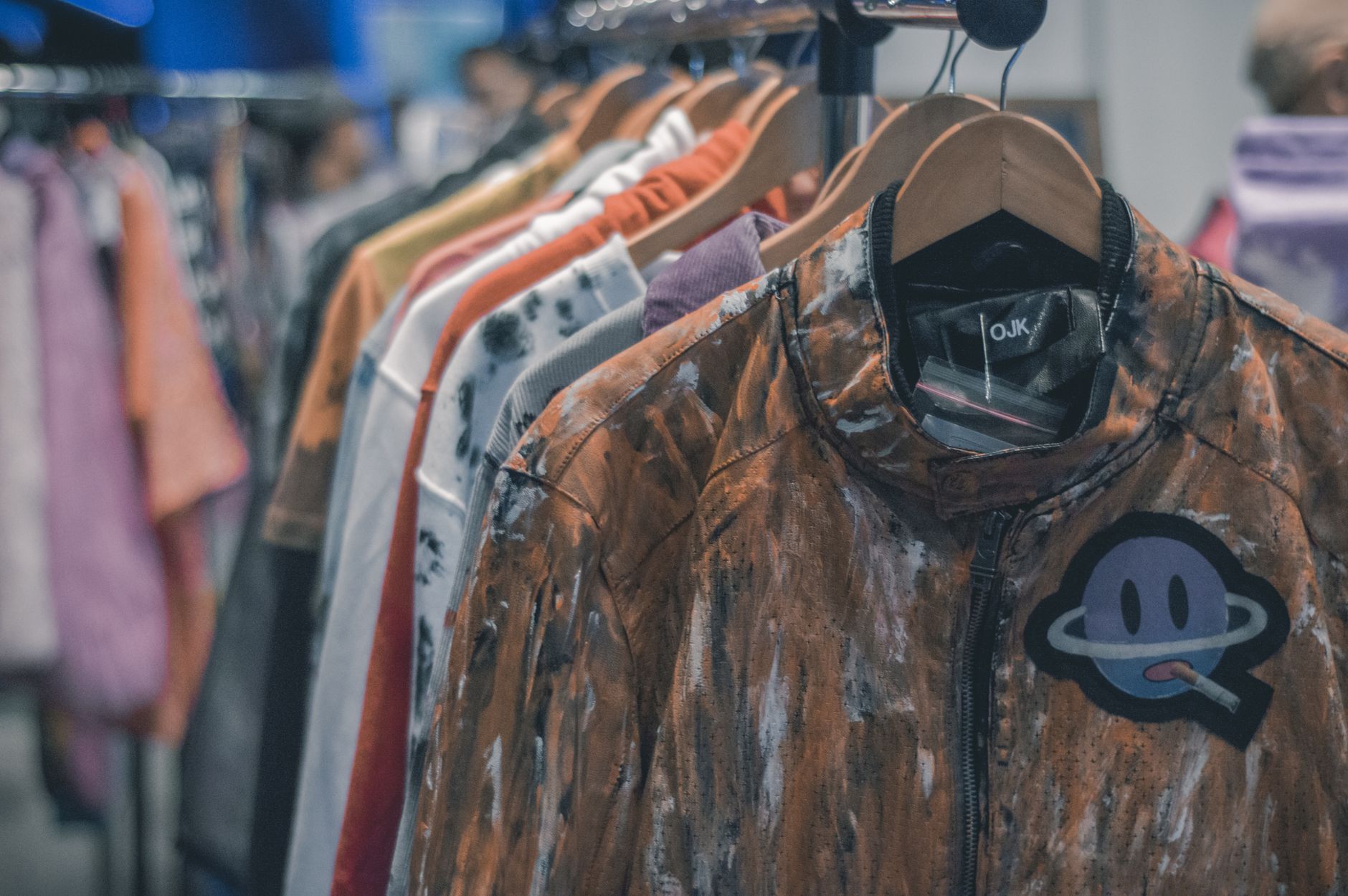 Vibrant streetwear garments hanging on a retail clothing rack