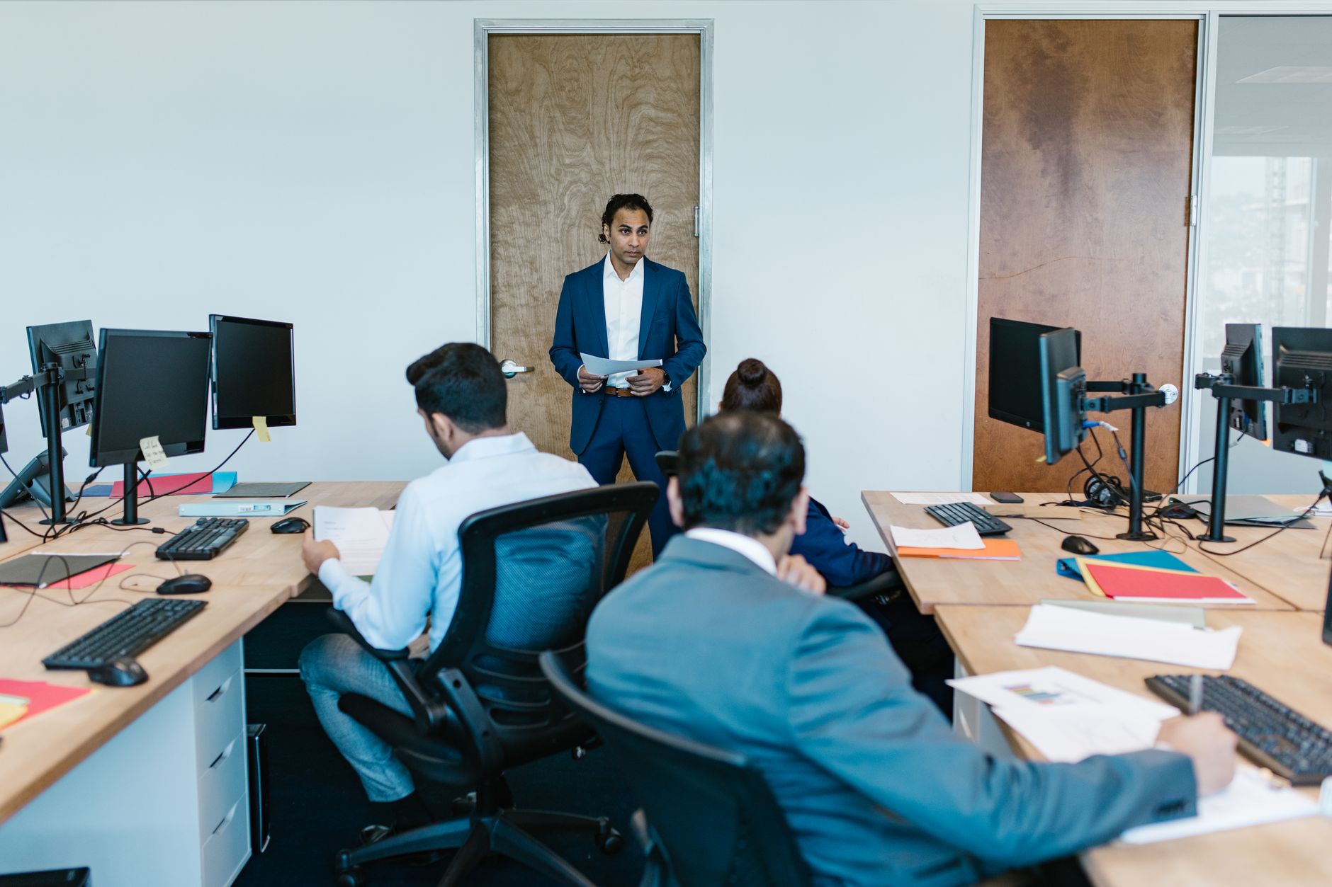 small professional team collaborating at desks in an open office