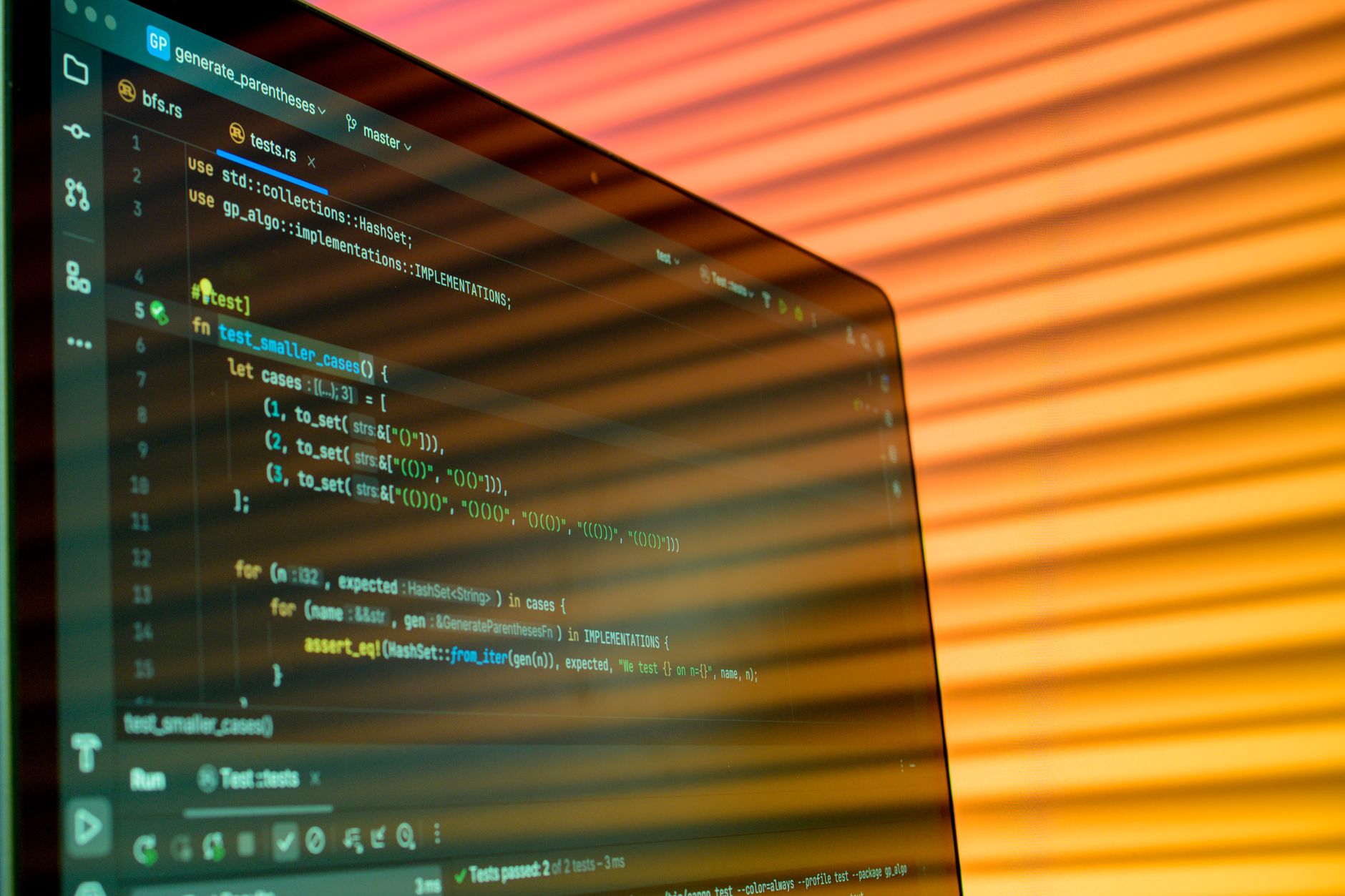 Lines of programming code displayed on a laptop screen in a dark room