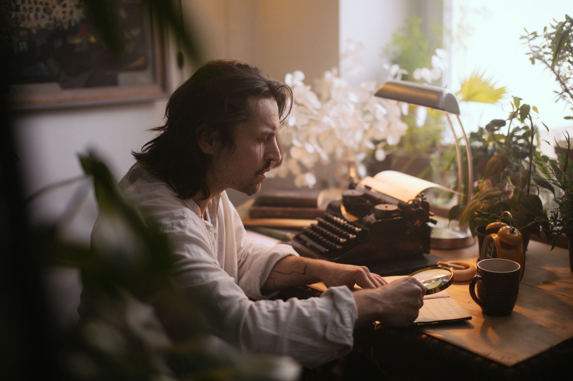 Vintage typewriter on a writer's desk with papers scattered around