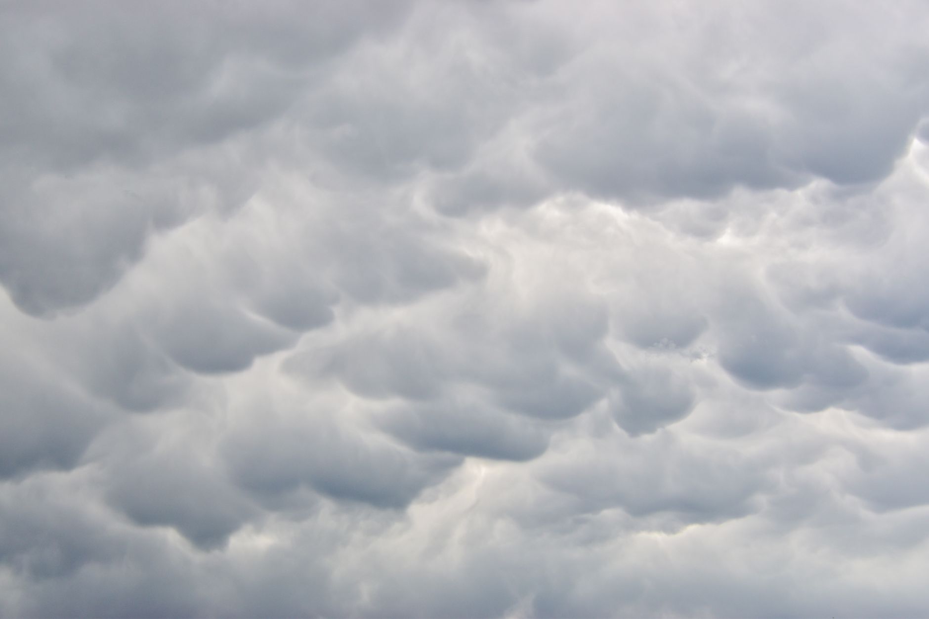 Long wispy cloud formation stretching across a wide open sky