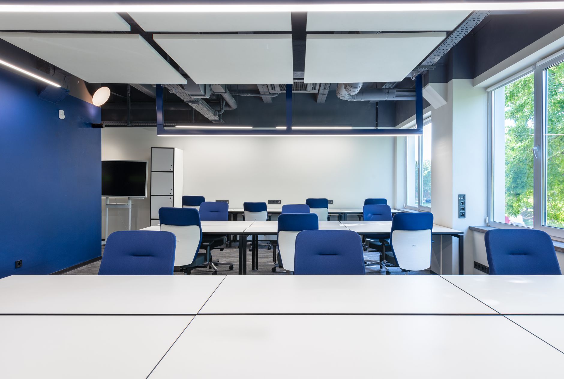 Empty corporate meeting room with chairs and a long conference table