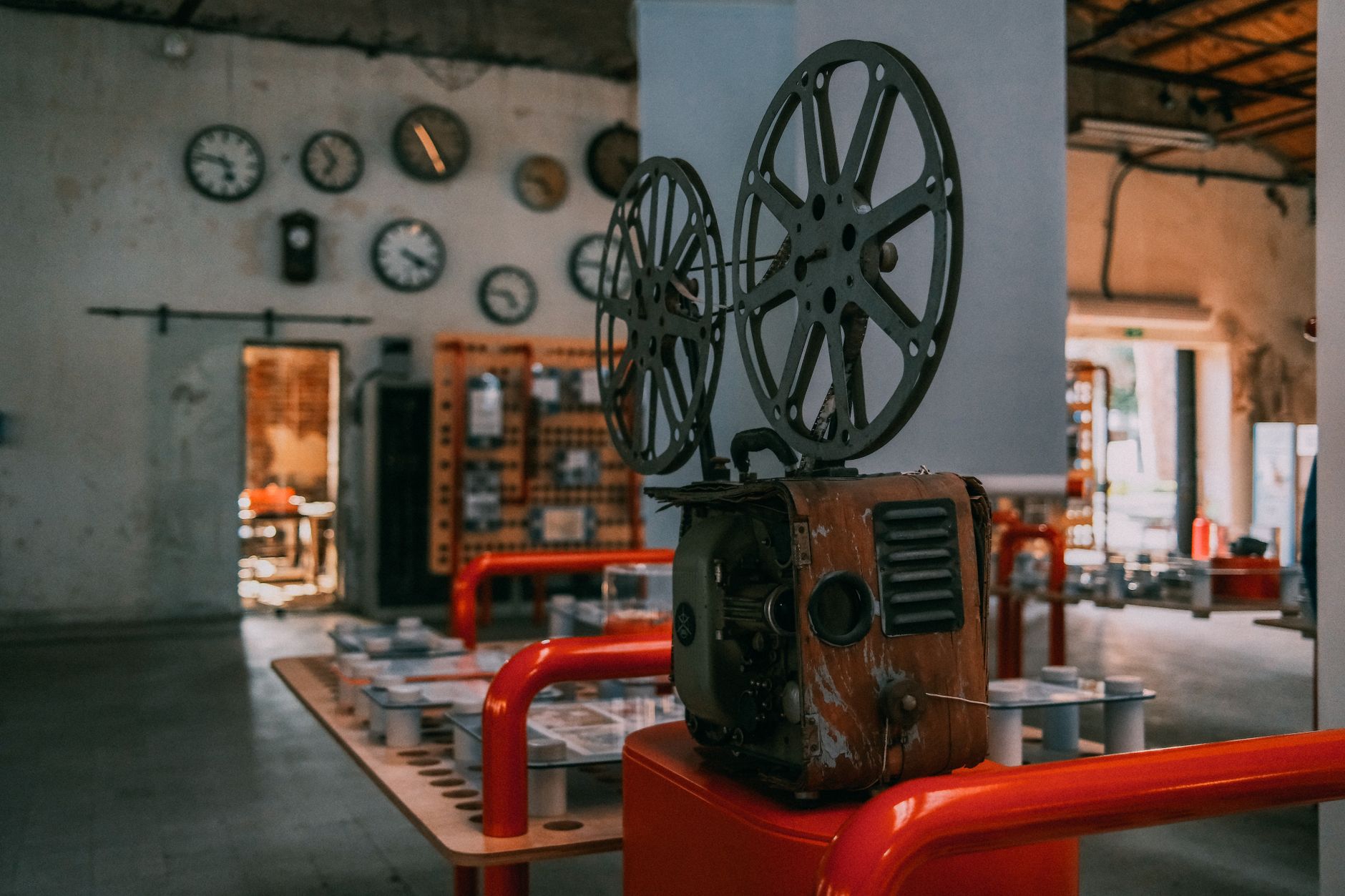 Classic film projector casting light in a darkened cinema
