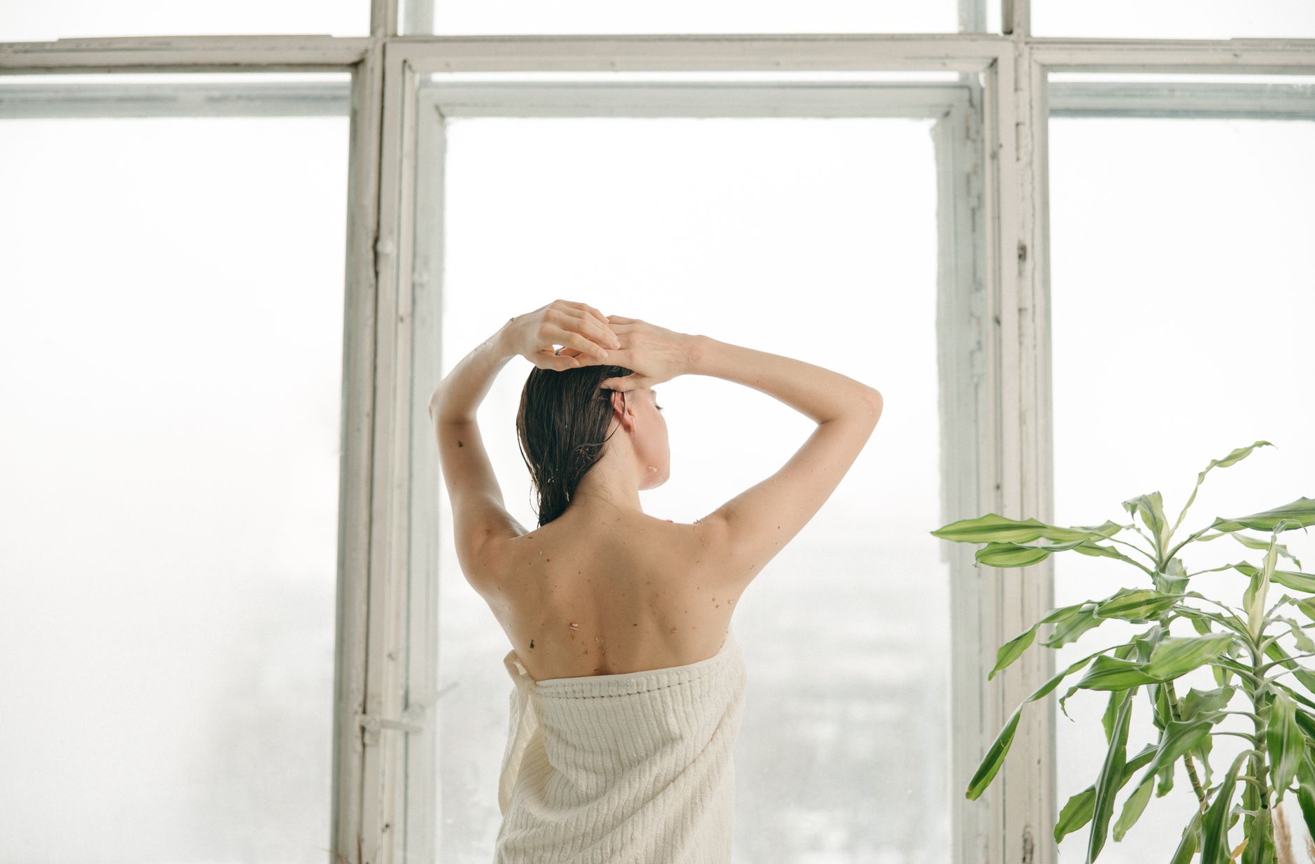 Person relaxing in a steam-filled bathhouse with ambient warm lighting