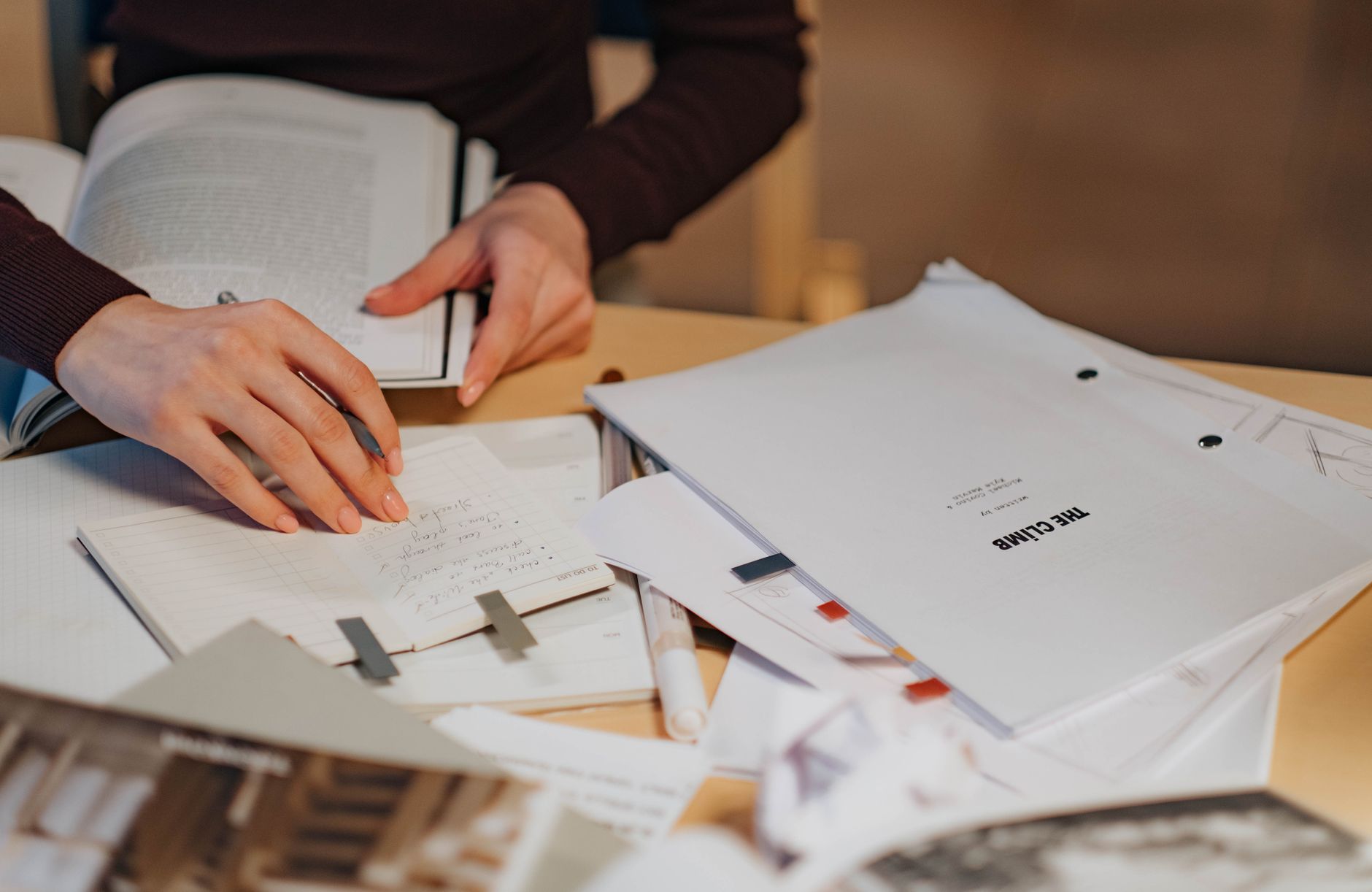 Open notebook and pen on a wooden writing desk