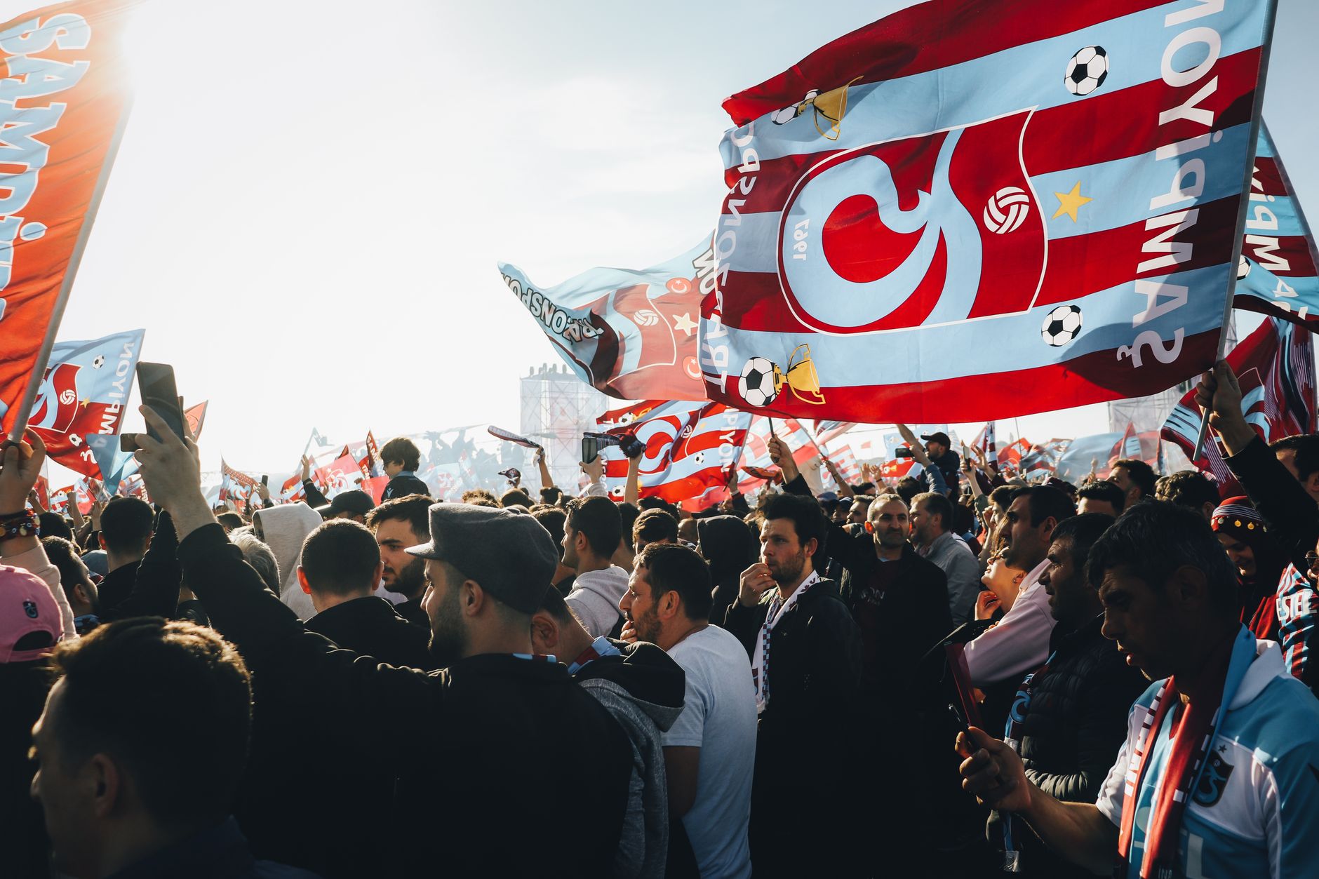 Large football stadium filled with supporters during a match