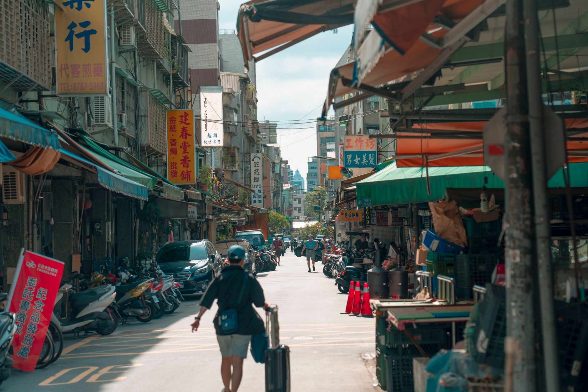 Busy street-level storefront in a Taiwanese urban neighborhood