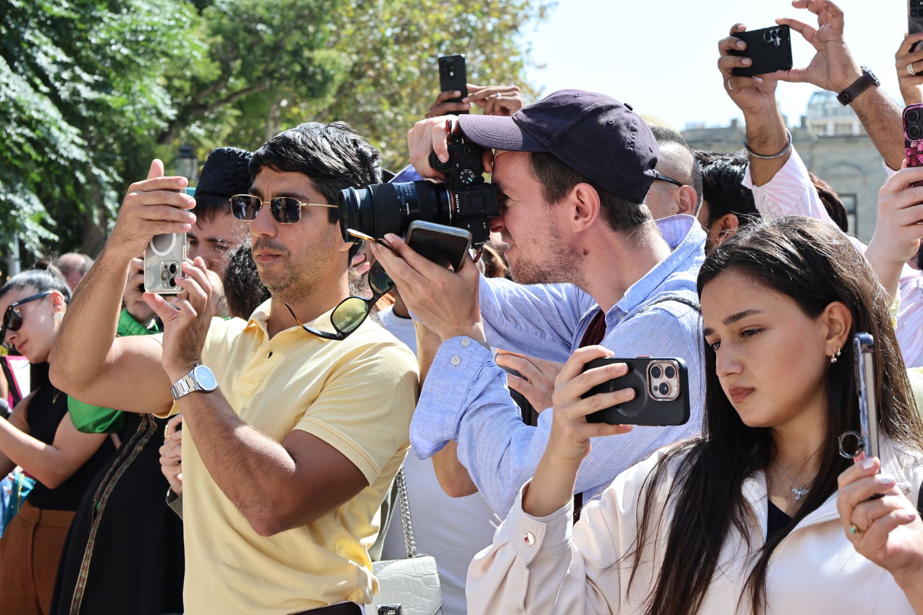 Attendees at an outdoor fashion gathering showing off layered statement outfits