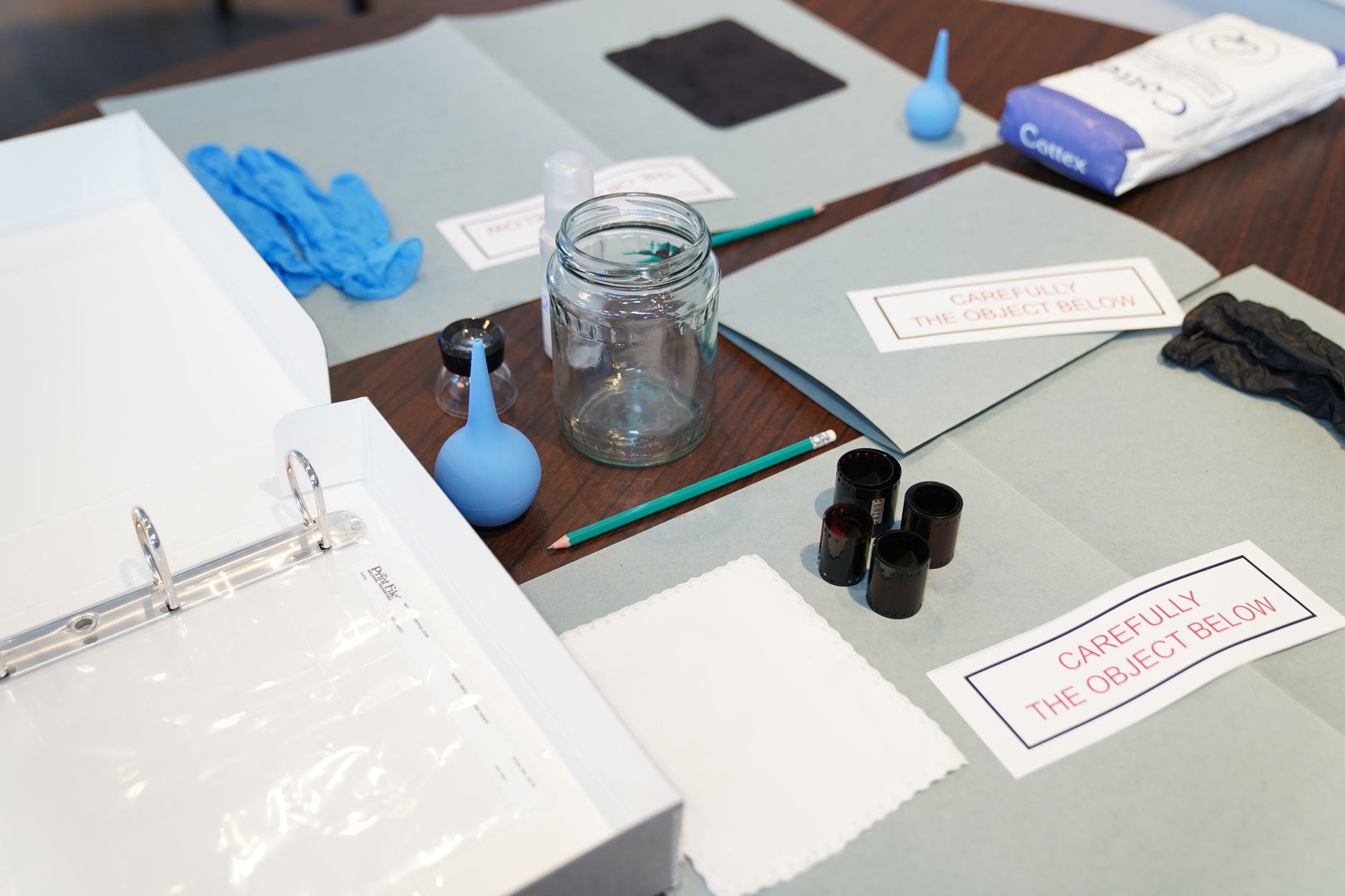 Researcher examining artifacts under forensic laboratory lighting