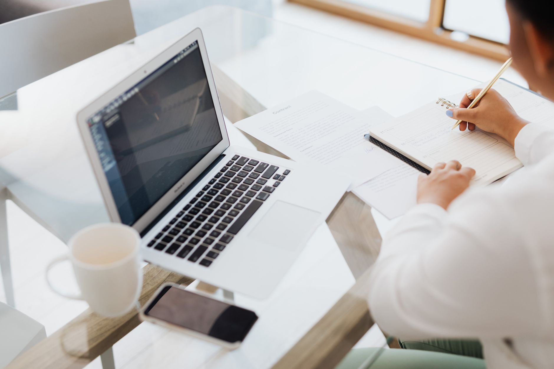 Person typing on a laptop at a minimalist home desk