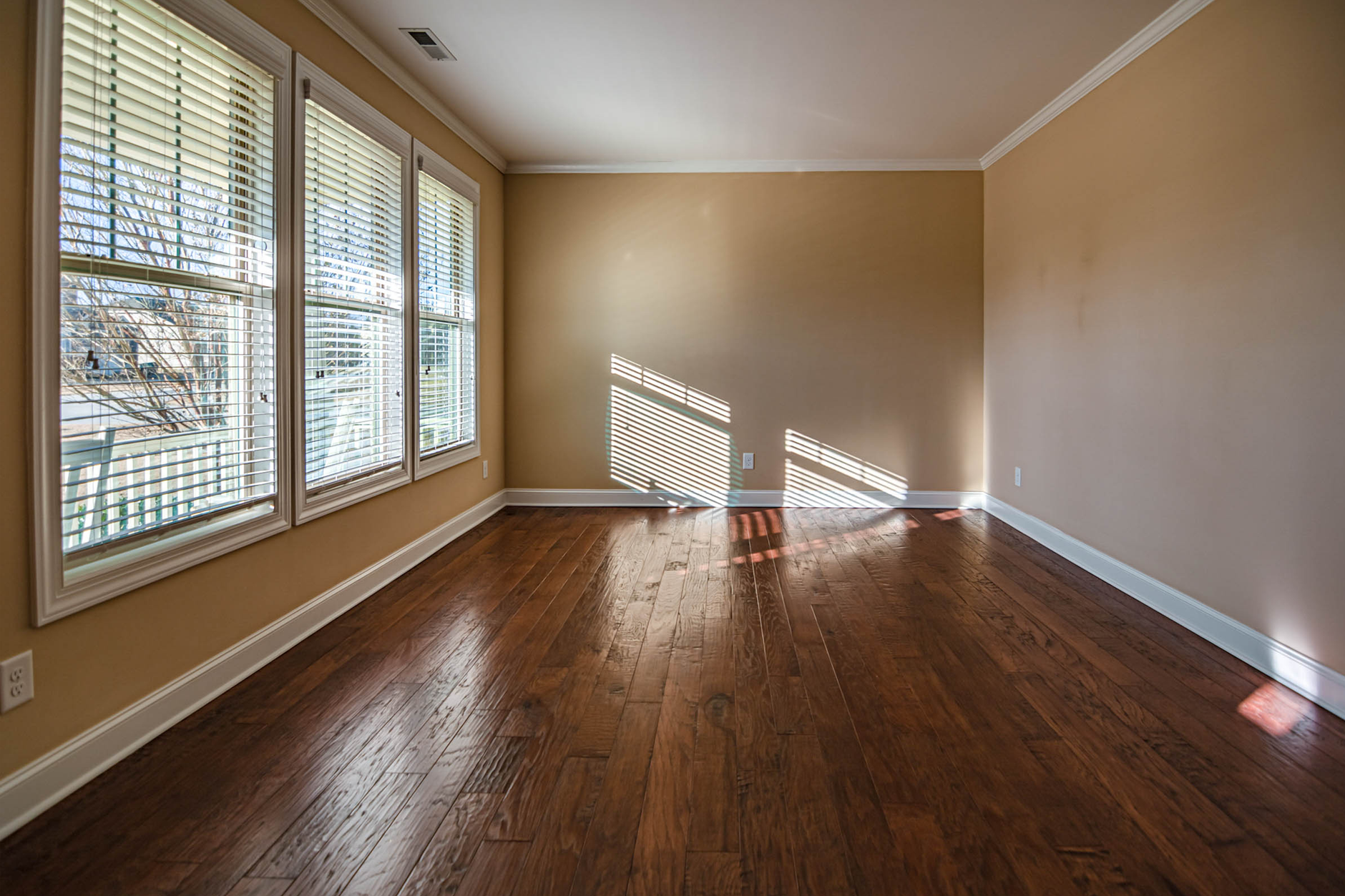 Empty room with light coming through a window, suggesting departure or absence
